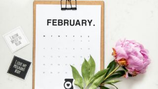 minimalist photography of a calendar and pink-petaled flower